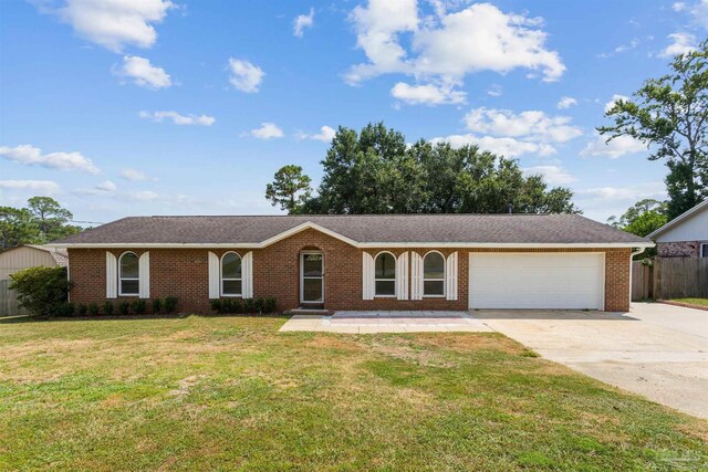 single story home with a garage and a front lawn