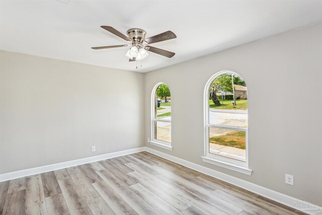 spare room featuring light wood-type flooring and ceiling fan