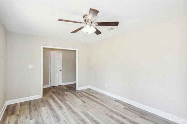 spare room featuring ceiling fan and light hardwood / wood-style flooring