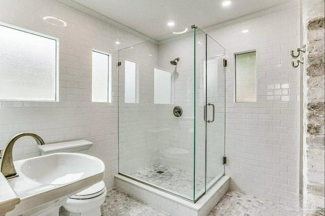 bathroom with sink, tile patterned flooring, an enclosed shower, toilet, and crown molding