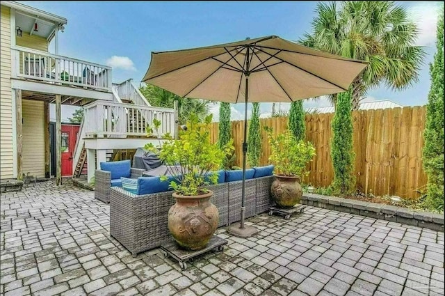 view of patio featuring a wooden deck and an outdoor living space