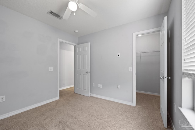 unfurnished bedroom featuring carpet floors, a closet, visible vents, and baseboards