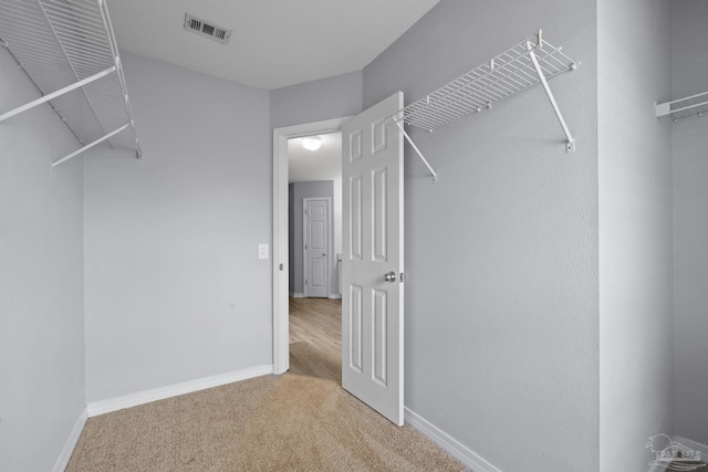 spacious closet with carpet and visible vents