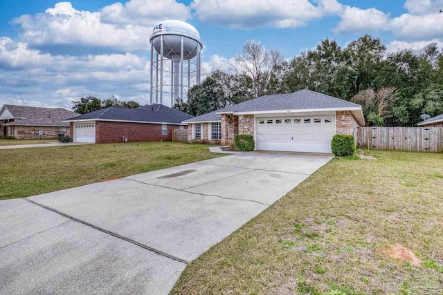 single story home featuring brick siding, fence, a garage, driveway, and a front lawn