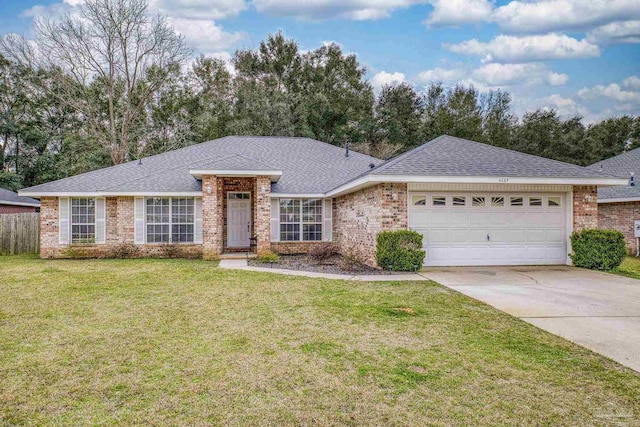 ranch-style home with a garage, concrete driveway, roof with shingles, a front yard, and brick siding