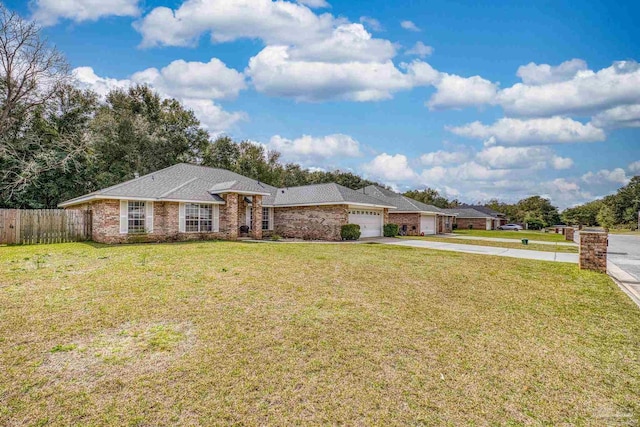 single story home with a garage, driveway, fence, a front yard, and brick siding