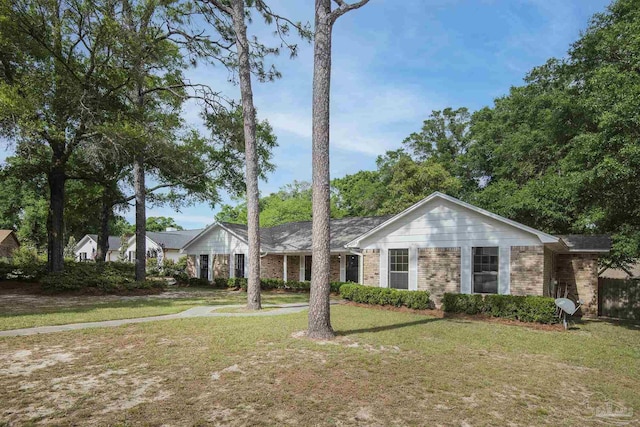 single story home with a front yard and brick siding