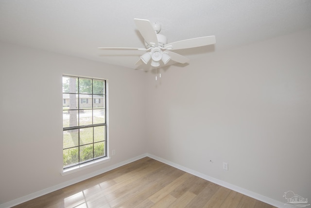unfurnished room featuring a ceiling fan, baseboards, and light wood finished floors