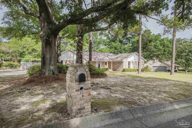 ranch-style home featuring fence