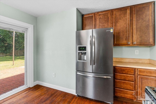 kitchen featuring dark wood-type flooring and stainless steel fridge