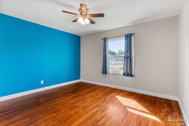 empty room with hardwood / wood-style flooring and ceiling fan