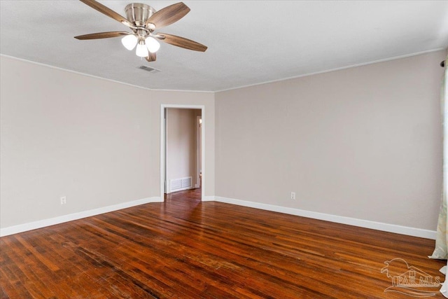 spare room featuring crown molding, dark hardwood / wood-style floors, and ceiling fan