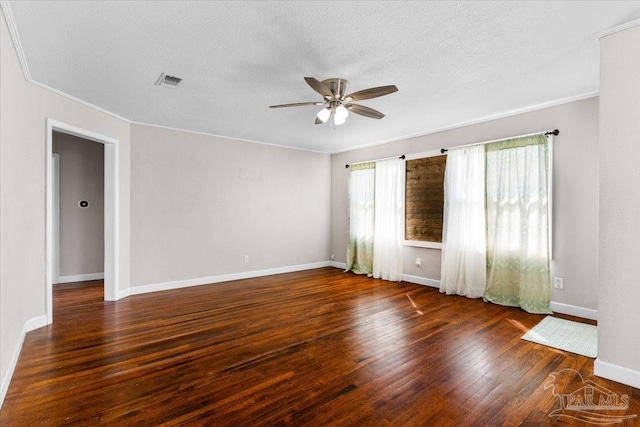 spare room with a textured ceiling, ornamental molding, dark hardwood / wood-style floors, and ceiling fan