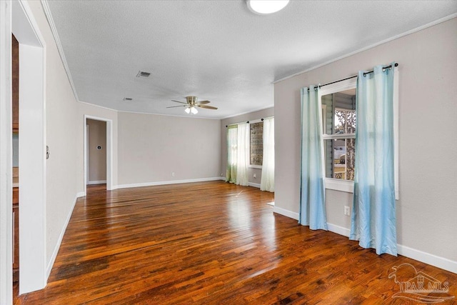 empty room with crown molding, a textured ceiling, dark hardwood / wood-style floors, and ceiling fan