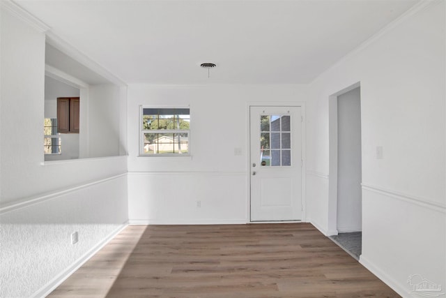 entrance foyer featuring crown molding and dark wood-type flooring