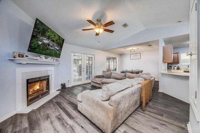 2000 Silverado Rd, Pensacola, FL 32506 - living area featuring vaulted ceiling, ceiling fan, healthy amount of natural light, french doors, and a tiled fireplace