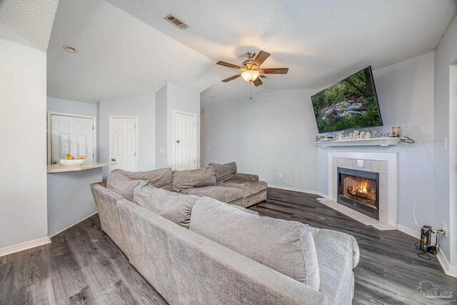 2000 Silverado Rd, Pensacola, FL 32506 - living room featuring a ceiling fan, vaulted ceiling, wood finished floors, baseboards, and a fireplace