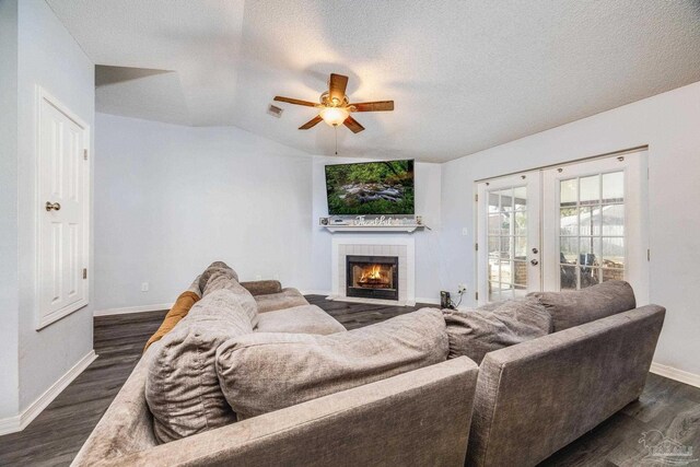 2000 Silverado Rd, Pensacola, FL 32506 - living area featuring ceiling fan, dark wood-type flooring, baseboards, a tiled fireplace, and a textured ceiling