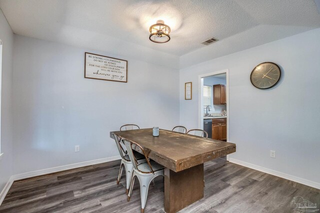 2000 Silverado Rd, Pensacola, FL 32506 - dining area with dark wood-style floors, baseboards, and a textured ceiling