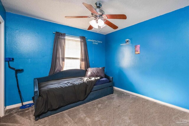 2000 Silverado Rd, Pensacola, FL 32506 - carpeted bedroom with a textured ceiling, ceiling fan, and baseboards