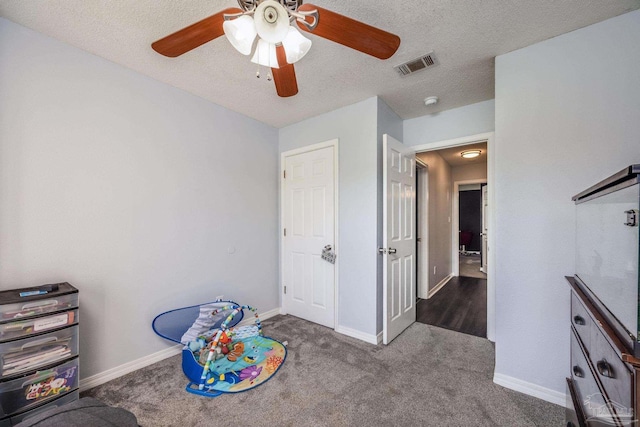 2000 Silverado Rd, Pensacola, FL 32506 - game room featuring a ceiling fan, a textured ceiling, carpet, and baseboards