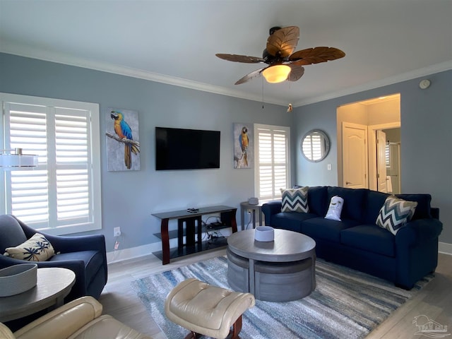 living room featuring hardwood / wood-style floors, crown molding, and ceiling fan