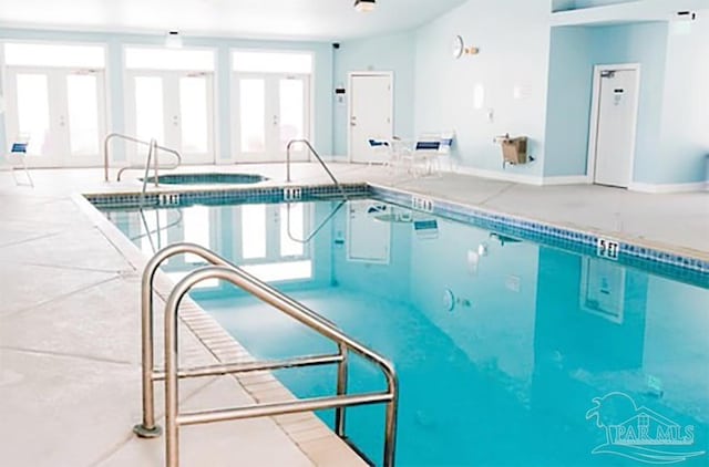 view of pool featuring french doors