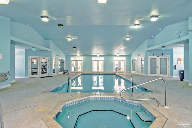 view of pool with french doors and an indoor in ground hot tub