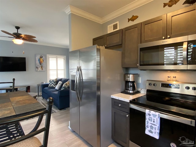 kitchen with dark brown cabinetry, crown molding, light wood-type flooring, appliances with stainless steel finishes, and ceiling fan