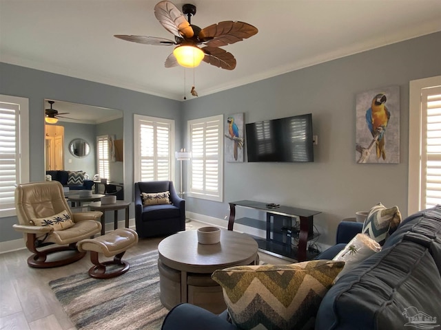 living room with crown molding, wood-type flooring, and ceiling fan