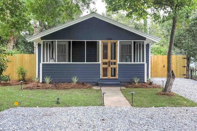 bungalow-style home with a front lawn