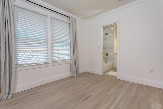 empty room with baseboards and light wood finished floors