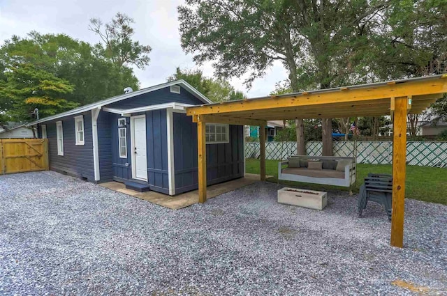 exterior space featuring a patio, fence, and board and batten siding