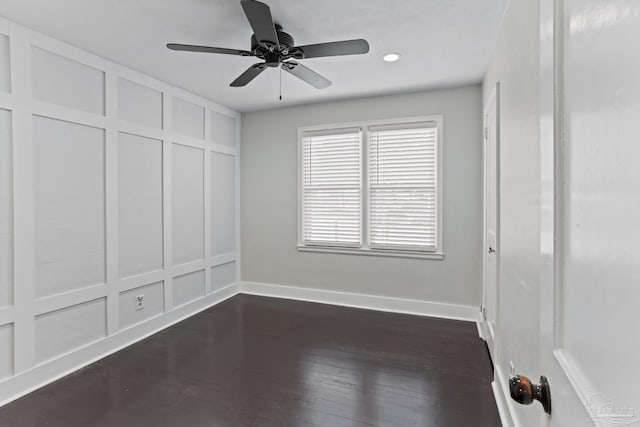 spare room with dark wood-type flooring and ceiling fan