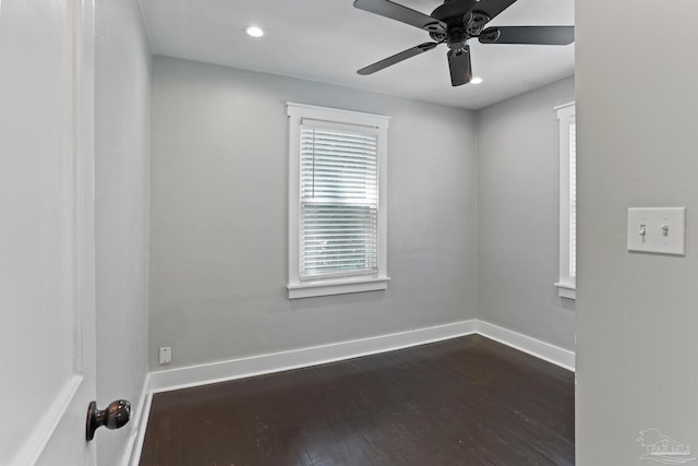 spare room featuring ceiling fan and dark hardwood / wood-style floors