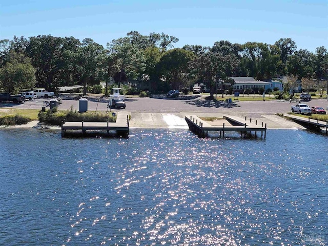 view of property's community featuring a water view and a dock