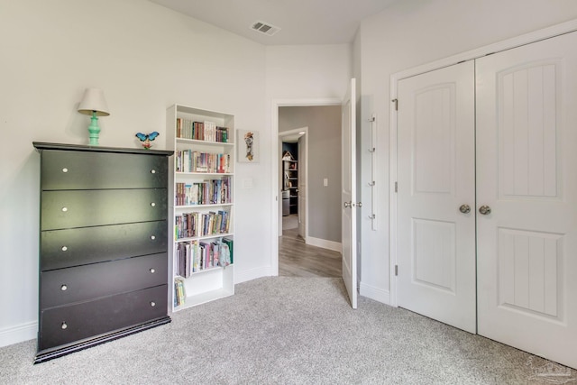 unfurnished bedroom with a closet, visible vents, baseboards, and carpet