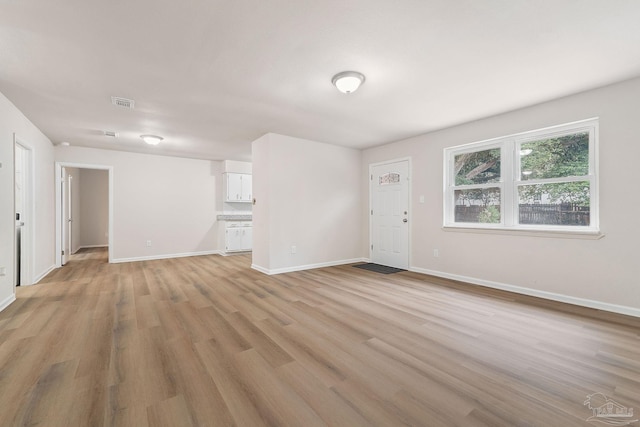 unfurnished living room featuring light hardwood / wood-style floors