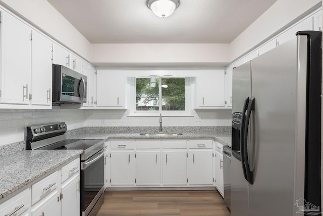 kitchen featuring white cabinetry, appliances with stainless steel finishes, sink, and backsplash