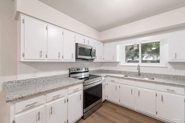 kitchen featuring white cabinetry, appliances with stainless steel finishes, and sink