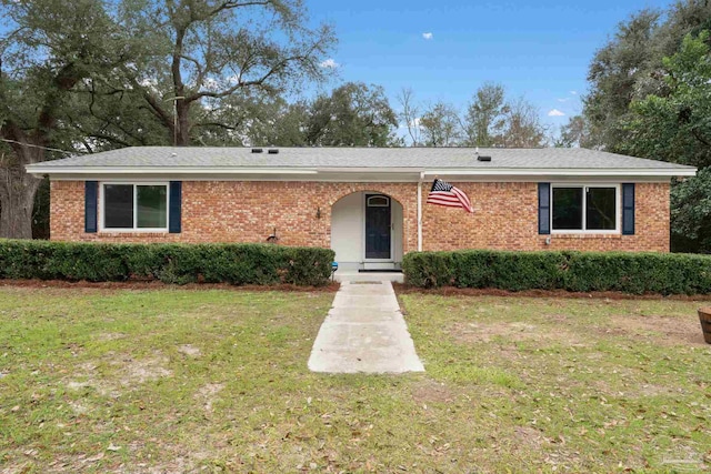 ranch-style home featuring a front yard