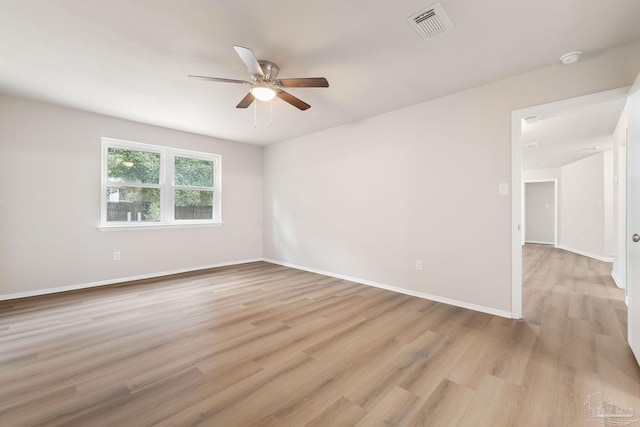 empty room with ceiling fan and light hardwood / wood-style floors