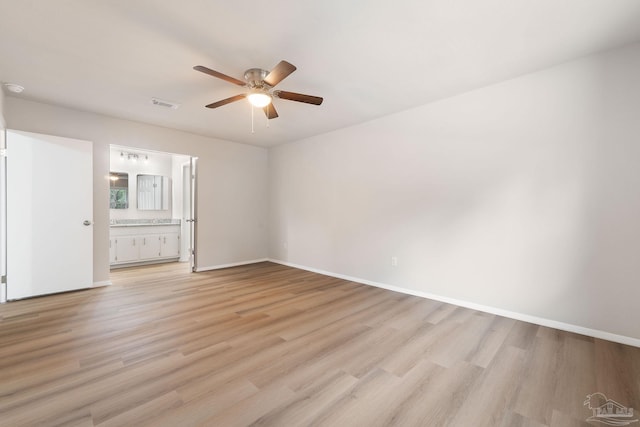 spare room with ceiling fan and light wood-type flooring