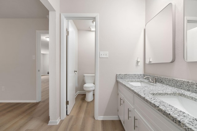 bathroom featuring hardwood / wood-style flooring, vanity, and toilet