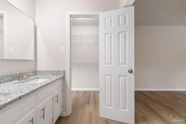 bathroom featuring hardwood / wood-style flooring and vanity