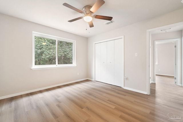 unfurnished bedroom featuring a closet, ceiling fan, and light hardwood / wood-style flooring