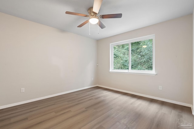 spare room featuring hardwood / wood-style flooring and ceiling fan