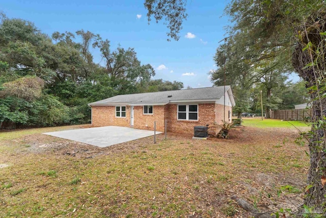 back of property featuring a yard, a patio area, and central air condition unit