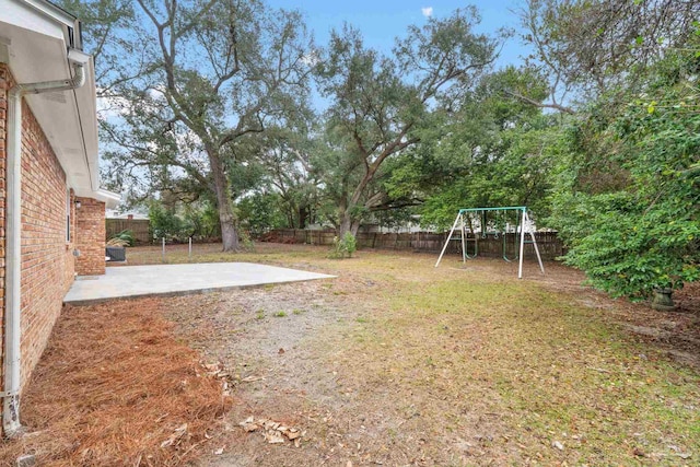 view of yard featuring a playground and a patio area