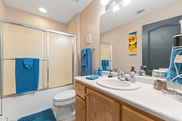 full bathroom with tile patterned flooring, visible vents, bath / shower combo with glass door, toilet, and vanity